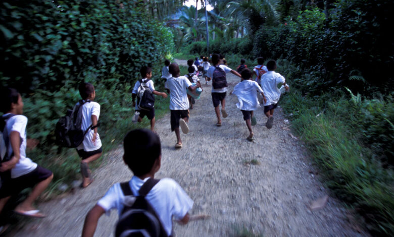 Children running in village lane