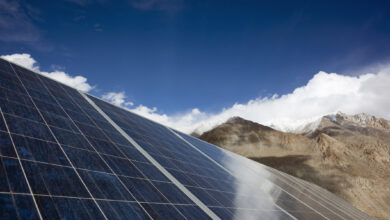 Solar panels in front of mountain range