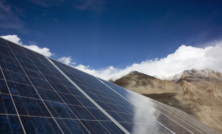 Solar panels in front of mountain range