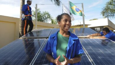 Student Brenda Rodrigues da Silva works on the installation of solar panels at Fábrica Social, a professional training centre in Brasília, Brazil.